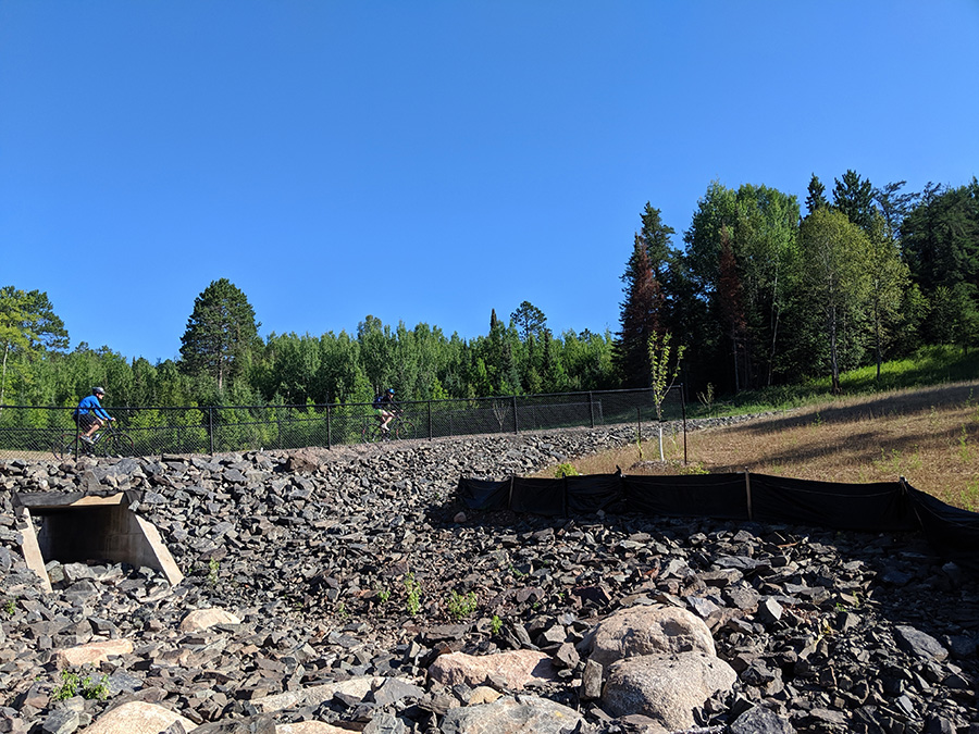 Bikers on the segment of the Mesabi Trail previous damaged by flooding.